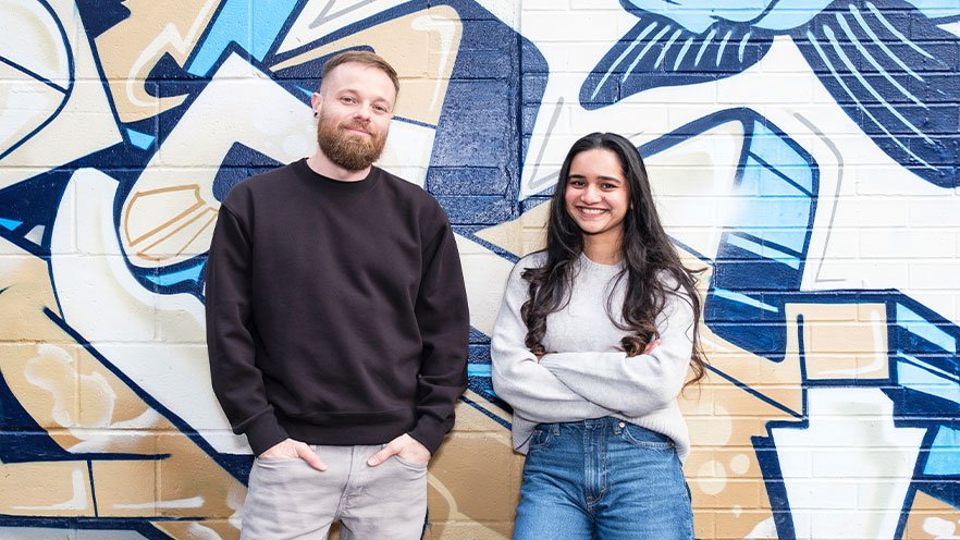 Website design and SEO services team at Idearium standing in front of a graffiti wall in Toronto.