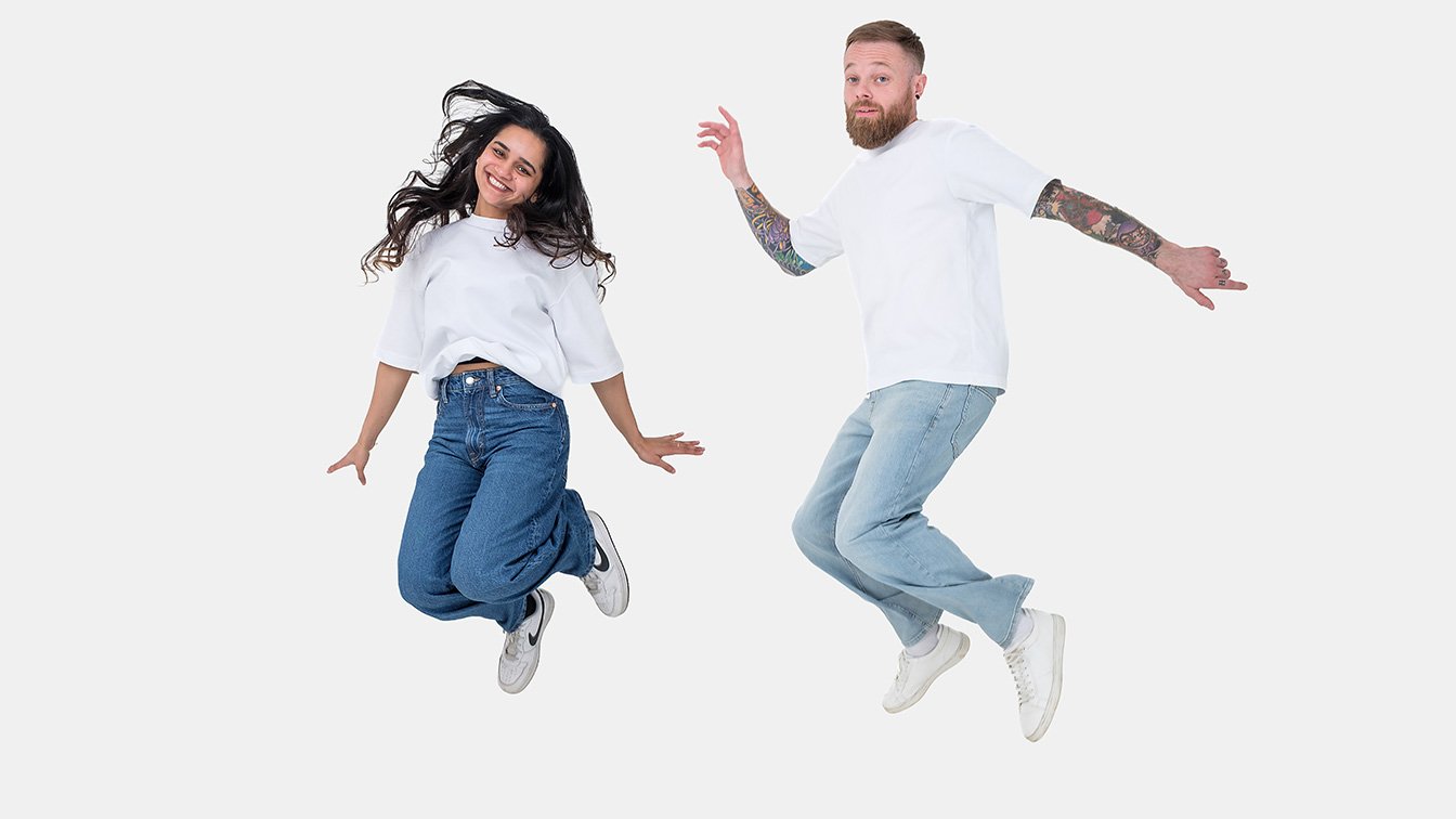 Portrait of two team members from idearium, an affordable web design and SEO agency, jumping in excitement.