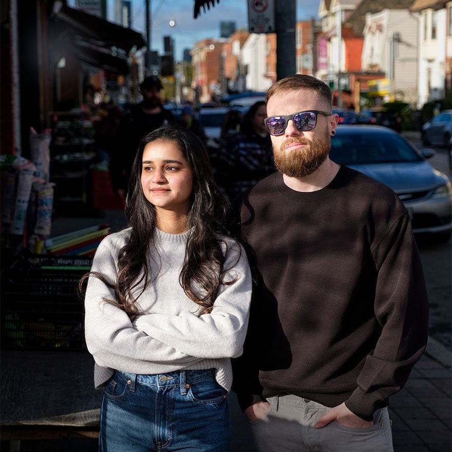 Two experts from idearium, a web design and SEO company, posing for portrait on a street in Toronto.