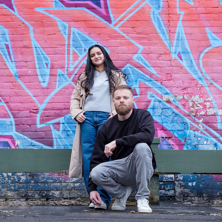 Professional website developer and SEO specialist from idearium, posing against a colorful graffiti wall in Toronto.